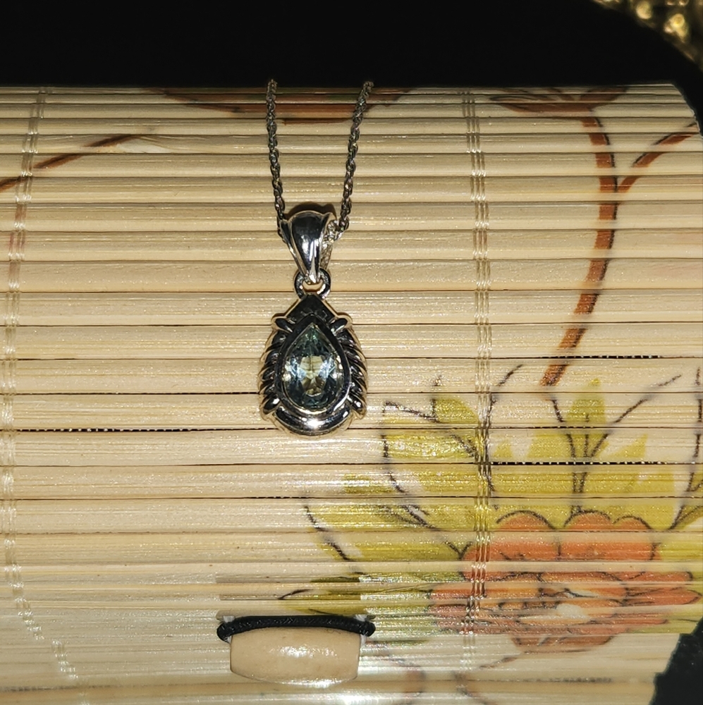 Women's 925 Blue Topaz Pear Cut Pendant Necklace on a 925 20" Singapore Chain.